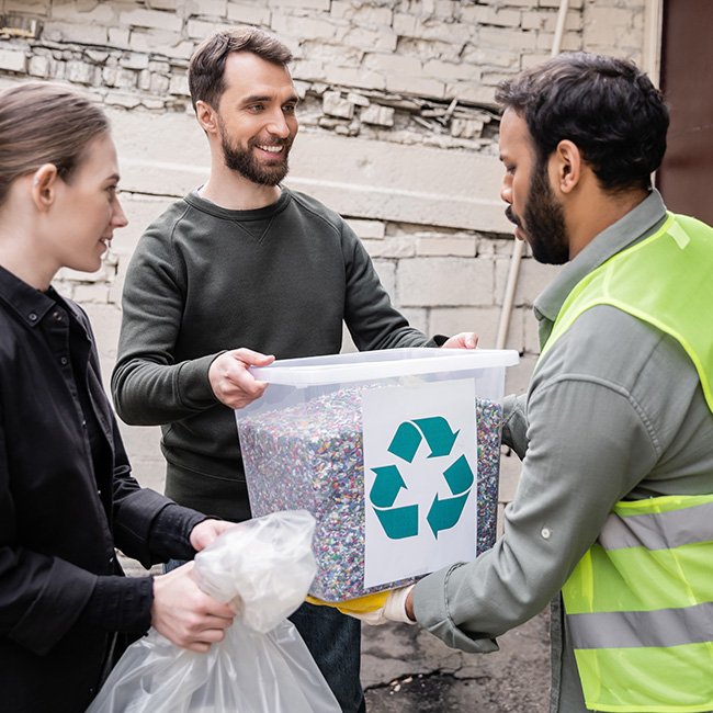 People collaborating to recycle collected plastic materials