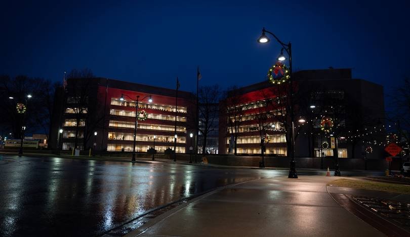 Night buildings with wreath-lit streetlamps