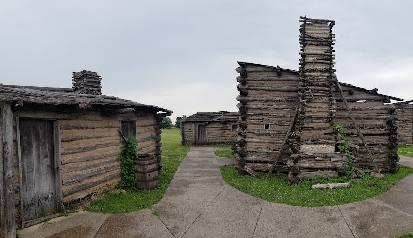 Old wooden cabins standing under overcast skies.