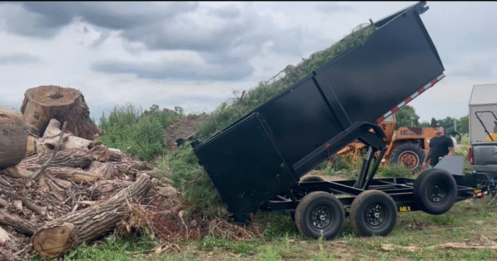 Dump trailer empties wood debris.