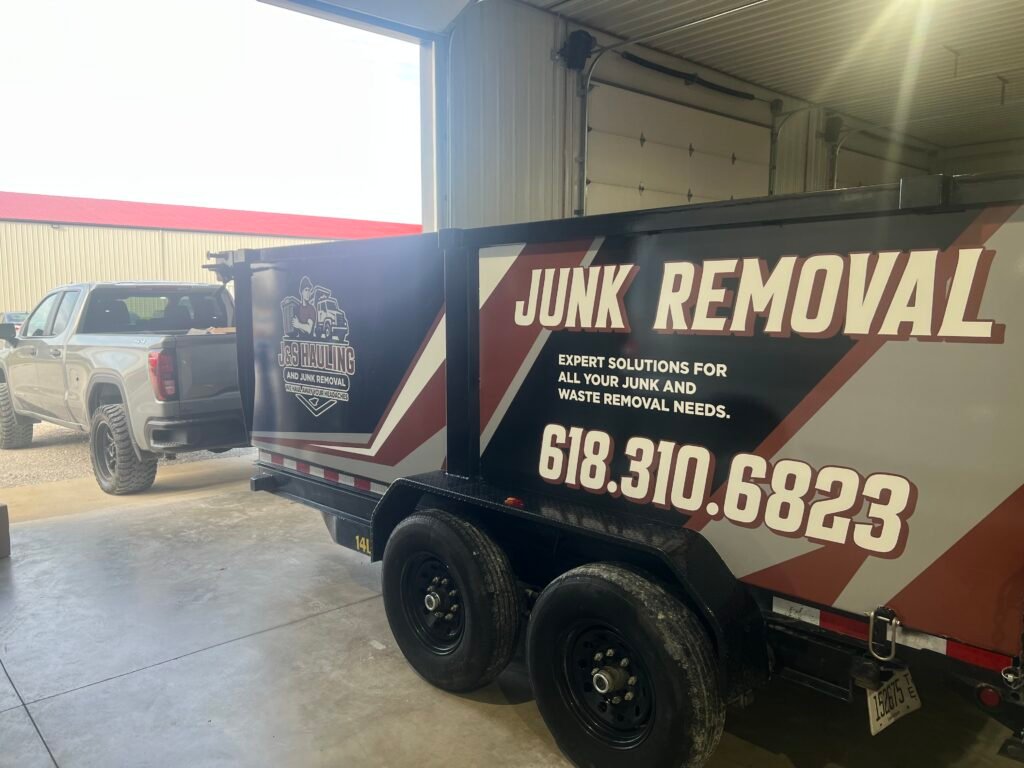Junk removal truck and hauling trailer parked