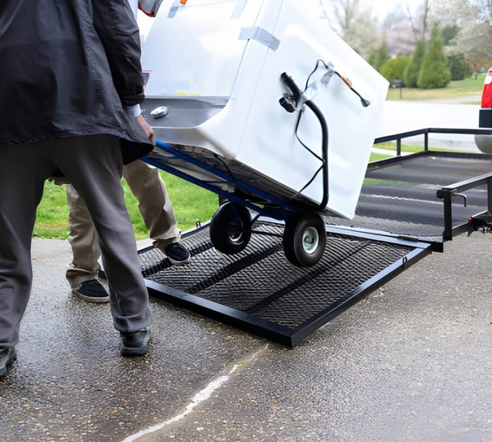 A black African-American man delivering a washing machine on a truck