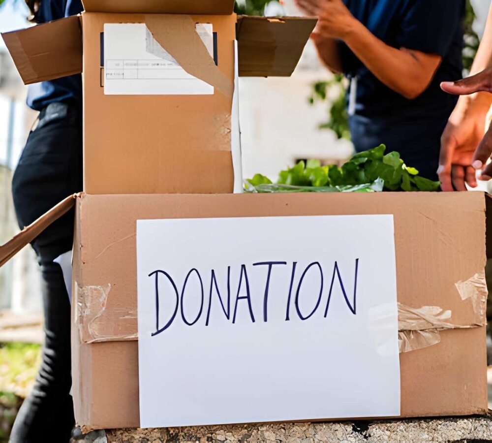 Donation box with people helping, related to junk removal services.