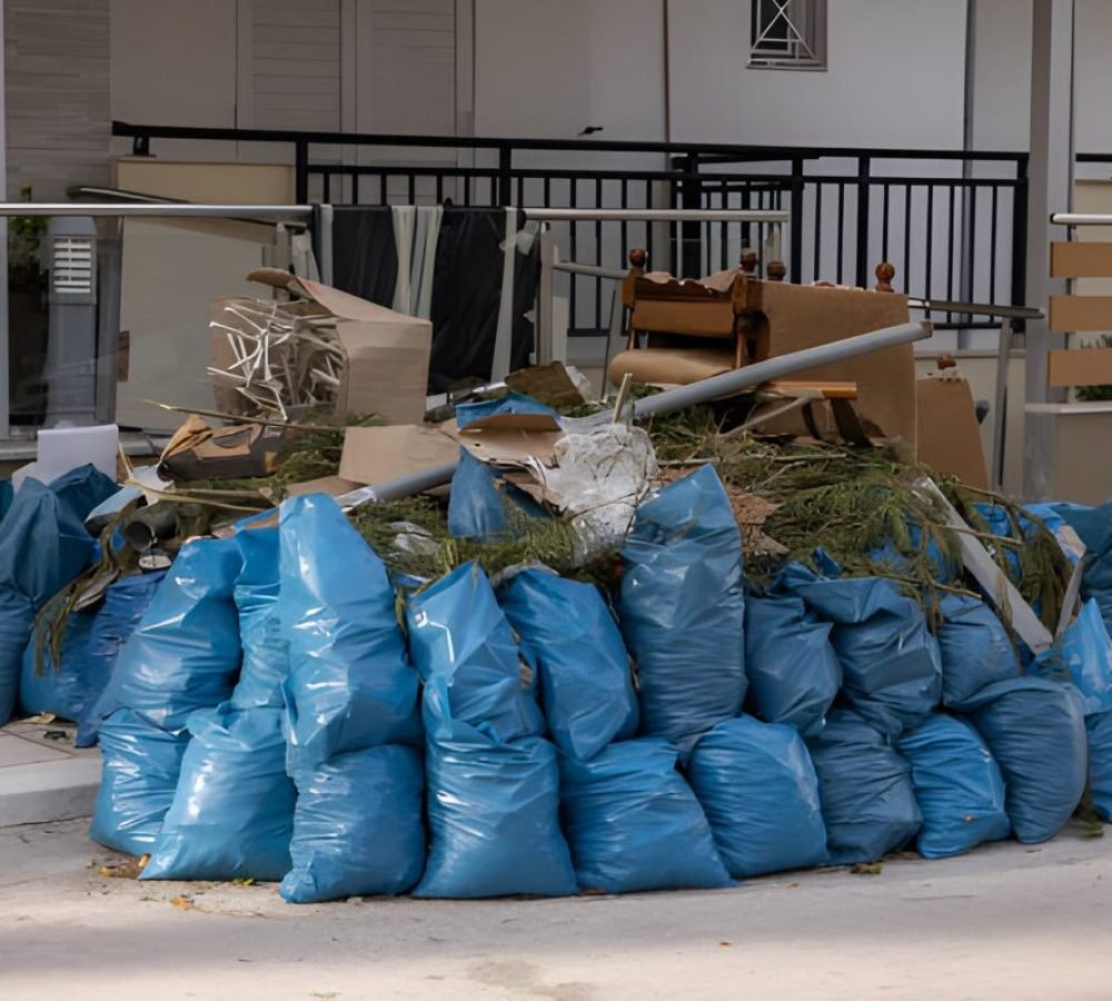 Large heap from rubbish bags on sidewalk in front of residential building