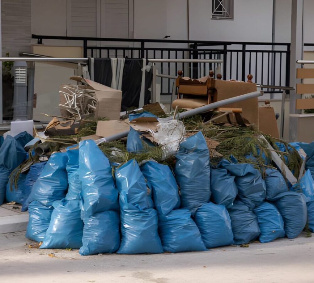 Large heap from rubbish bags on sidewalk in front of residential building