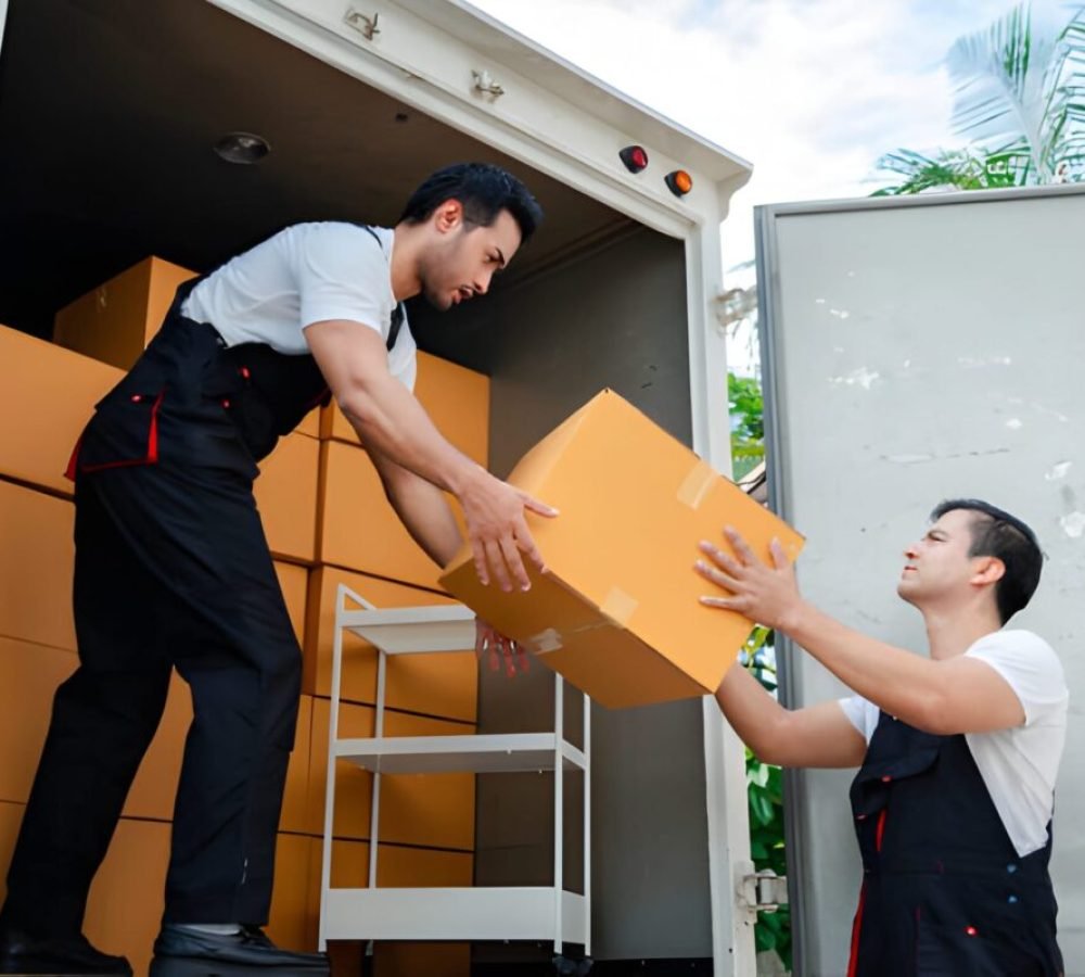 Unloading boxes and furniture from a pickup truck to a new house with service cargo two men movers worker in uniform lifting boxes.